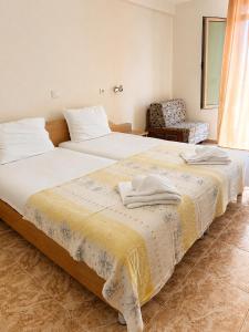 a bedroom with two beds and a chair in it at Hotel Palace in Kranevo +77 photos
