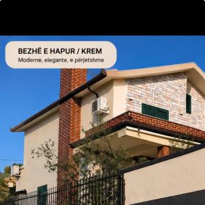a building with a sign that reads bele e happy khen at Vila Relax, Manez Durrës in Manzë