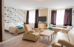 a room with a living room with a couch and a bed at PATIO dom gościnny in Łukęcin