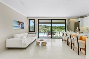 a living room with a white couch and a table at Meganisi Villas Royal in Meganisi