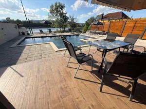 a patio with a table and chairs next to a pool at AdDrinum in Gornja Koviljača
