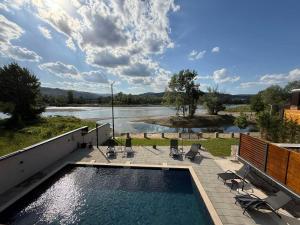 a swimming pool with a view of a river at AdDrinum in Gornja Koviljača