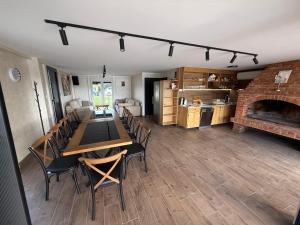 a dining room with a table and chairs and a fireplace at AdDrinum in Gornja Koviljača