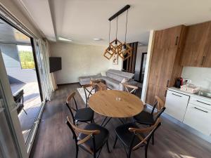 a kitchen and dining room with a table and chairs at AdDrinum in Gornja Koviljača