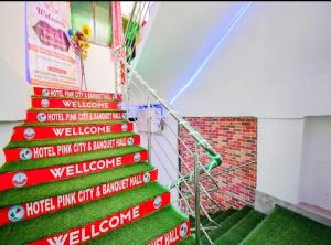 a stairway with signs on the side of a building at Hotel Pink City& Banquet in Dīgha