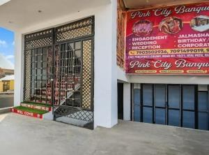 a store front with a gate and a sign on it at Hotel Pink City& Banquet in Dīgha