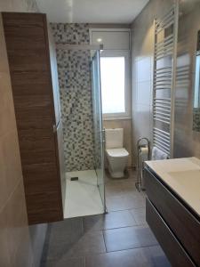 a bathroom with a toilet and a glass shower at Clot d'en Baldà in Berga +11 photos