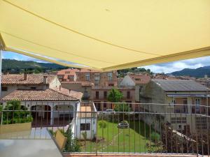 a yellow canopy over a balcony with buildings at Clot d'en Baldà in Berga