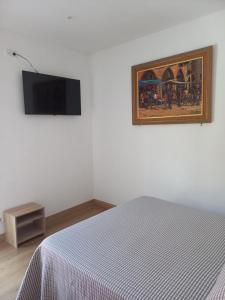 a bedroom with a bed and a painting on the wall at Clot d'en Baldà in Berga