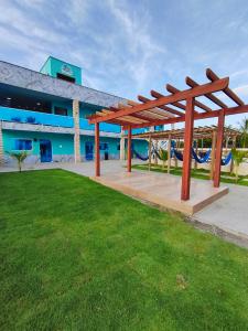 a pavilion in front of a building with a playground at Pousada Imperio Azul in Santo Amaro