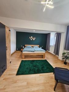 a bedroom with a bed and a green wall at Ferienwohnung Stella in Zülpich