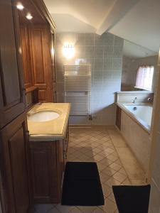 a small bathroom with a sink and a tub at Maison de charme en pierre in Morville +7 photos