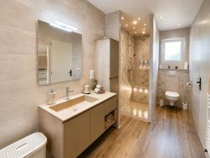 a bathroom with a sink and a shower and a toilet at Gîte Autour d'Opale in Cucq +23 photos