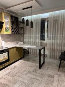 a kitchen with a table and a counter top at Pearl KadoRR in Liski +11 photos