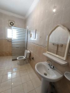 a bathroom with a sink and a toilet and a mirror at الامتياز in Jeddah