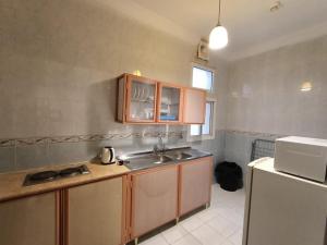 a kitchen with a sink and a refrigerator at الامتياز in Jeddah +6 photos