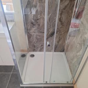 a shower with a glass door in a bathroom at Parciau barn in Clyro +11 photos