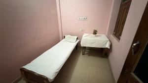 a hospital room with a bed and a table at Hotel Akshni Palace in Pūrnia