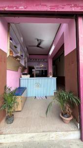 a restaurant with a bar in a pink building at Hotel Akshni Palace in Pūrnia
