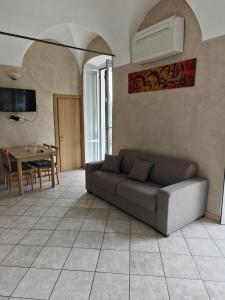 a living room with a couch and a table at Garibaldi 39 in Loano