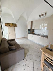 a living room with a couch and a kitchen at Garibaldi 39 in Loano +5 photos