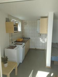 a small kitchen with a stove and a microwave at Mierzyn Po Drodze in Mierzyn