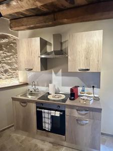 a kitchen with a sink and a stove at Casa Vacanze Partenzi in Vallo di Nera +10 photos
