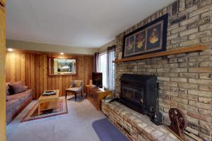 a living room with a brick wall with a fireplace at Discovery 4 119 in Mammoth Lakes