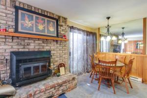 a living room with a fireplace and a table and chairs at Discovery 4 119 in Mammoth Lakes