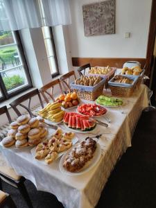 a table filled with different types of food on at Hotel Veba in Broumov