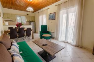 a living room with a couch and a table at MARINA in Perama