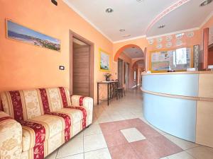 a living room with two couches and a bar at Pensione Affittacamere Miriam in Scalea