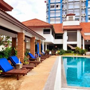 a resort with a pool and lounge chairs next to a building at Sport Villa Condo in Hua Hin