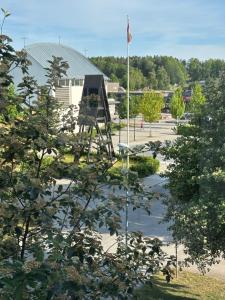 a view of a park with a flag and a building at Viksjo Centrum Apartment in Järfälla