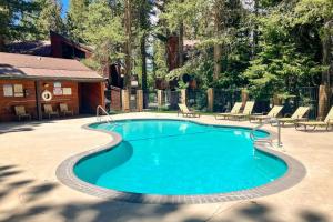 a swimming pool in a yard with chairs around it at Meadow Ridge 34 in Mammoth Lakes