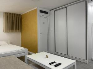 a room with a bed and a white table at Relax Apartmani in Sutomore +166 photos