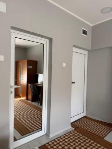 a hallway with a mirror and a room with a desk at Apart Hotel Lyubimets in Lyubimets