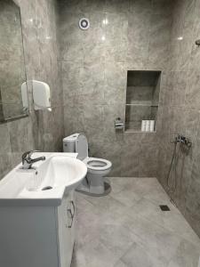 a bathroom with a sink and a toilet at Apart Hotel Lyubimets in Lyubimets +20 photos