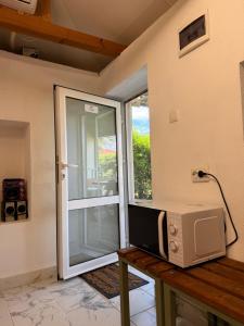 a microwave sitting on a table next to a sliding glass door at Apart Hotel Lyubimets in Lyubimets
