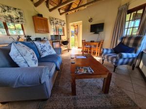 a living room with a couch and a coffee table at Otters Den in Nottingham Road