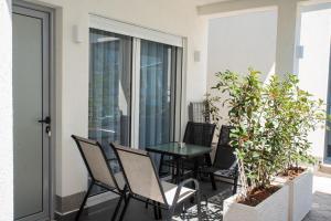 a patio with chairs and a table on a balcony at Casa Al Mare in Ulcinj