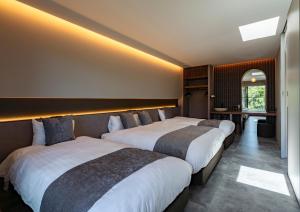 a hotel room with two beds in a room at REQUIES first bloom in Kawazu
