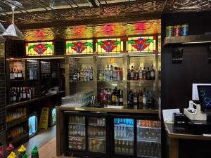 a bar with stained glass windows in a liquor store at Queens Hotel Belfast in Belfast
