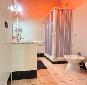 a bathroom with a toilet and a shower and a sink at Pensione Affittacamere Miriam in Scalea +29 photos