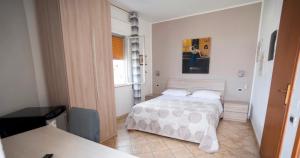 a small bedroom with a bed and a window at Hotel Belvedere Lampedusa in Lampedusa