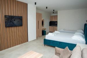 a hotel room with two beds and a couch at Casa Al Mare in Ulcinj