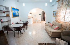 a living room with a couch and a table and chairs at Hotel Belvedere Lampedusa in Lampedusa