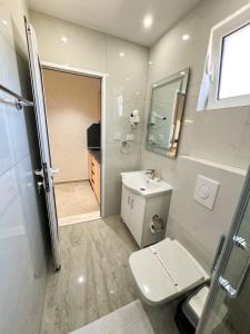 a bathroom with a toilet and a sink and a shower at Casa Al Mare in Ulcinj +59 photos