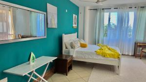 a bedroom with a bed and a desk and a window at Mtwapa Beach Nest D3 in Mtwapa +63 photos