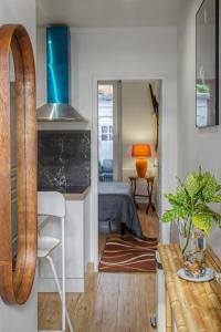 a living room with a kitchen and a bedroom at Lux PIGALLE in Argenteuil